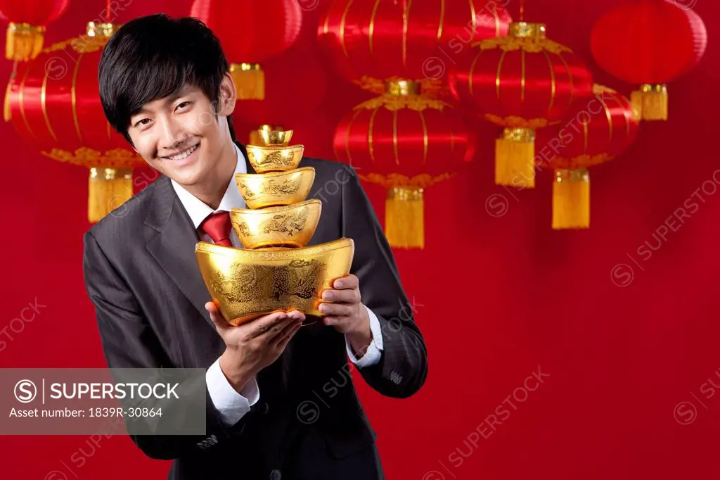 Businessman Holding Chinese Gold Yuanbao
