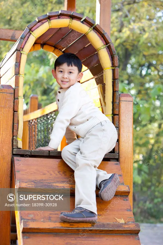 Boy playing on playground toys