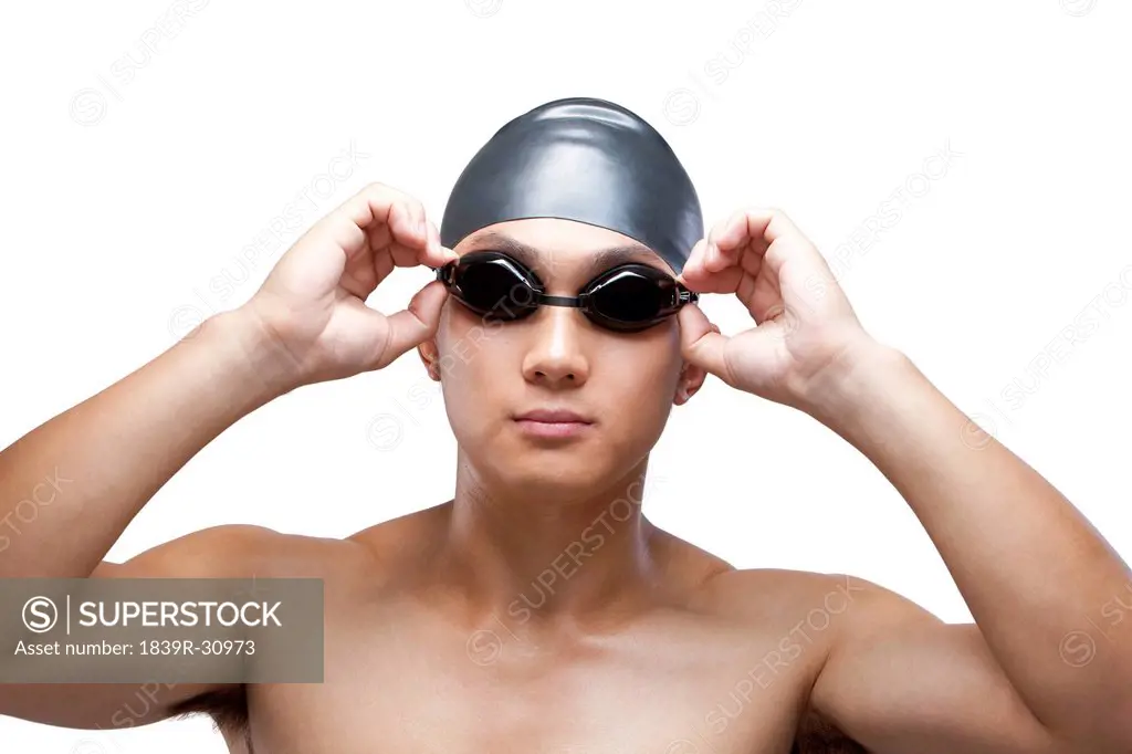Swimmer fixing his goggles
