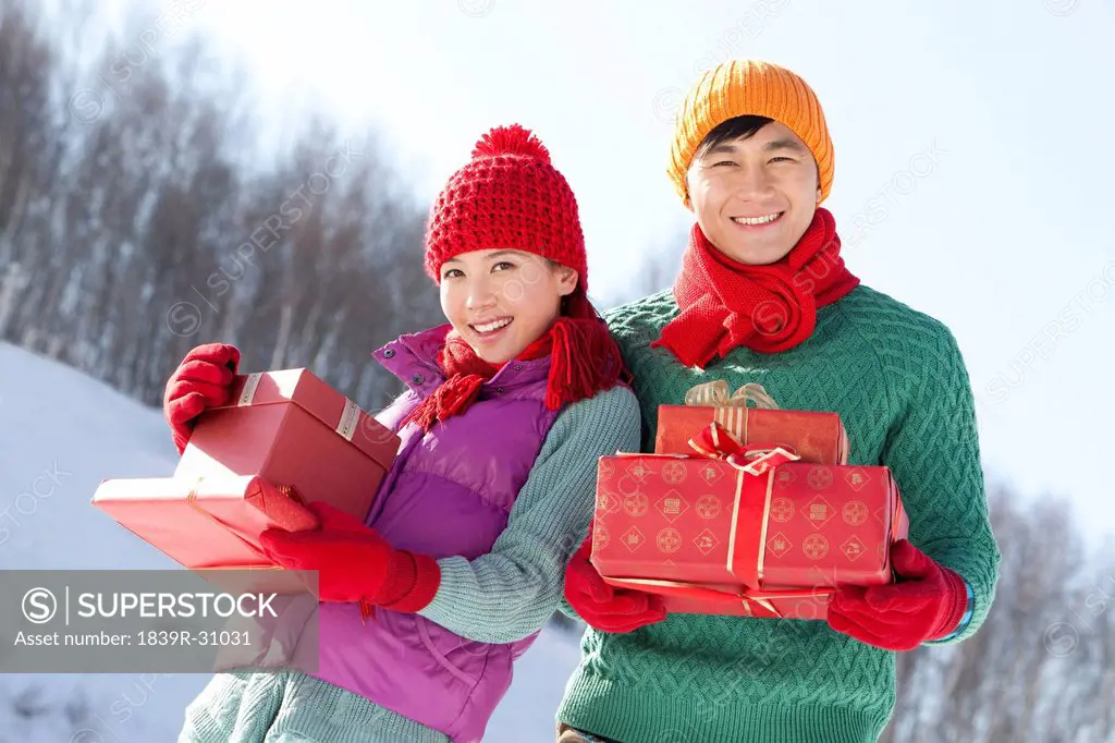 Young people holding gift boxes