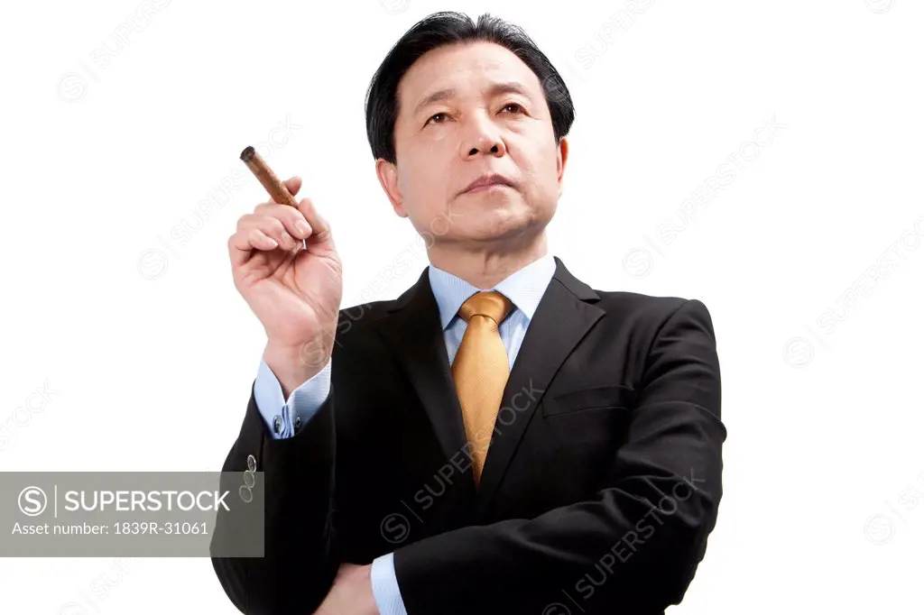 Senior businessman smoking a cigar