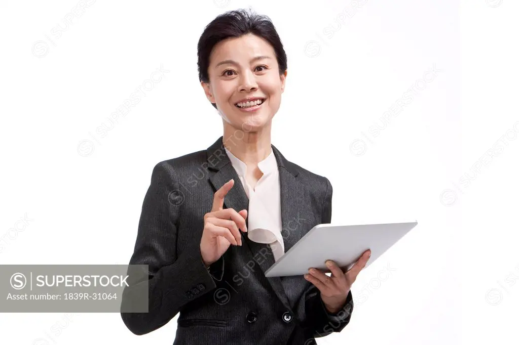 Middle_aged businesswoman using digital tablet