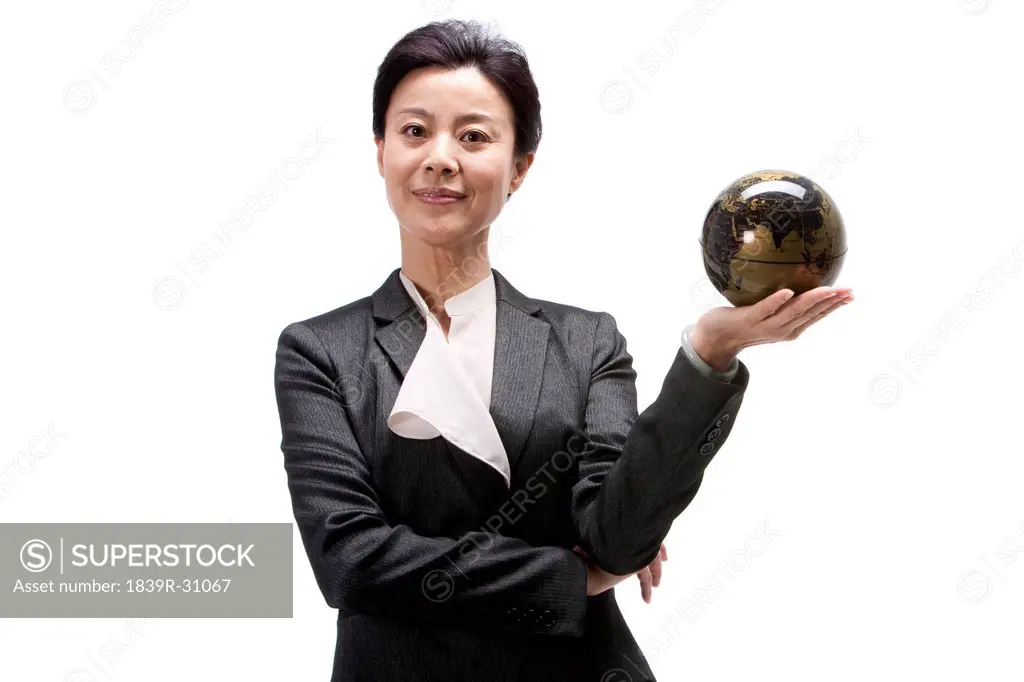 Middle_aged businesswoman holding a globe