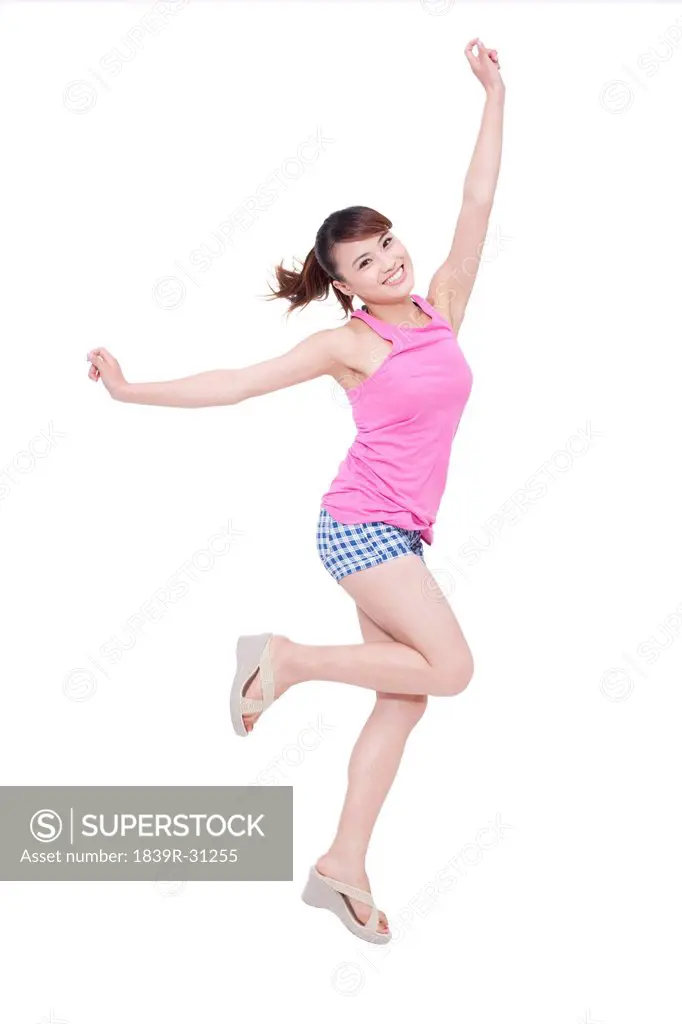 Cheerful young woman jumping