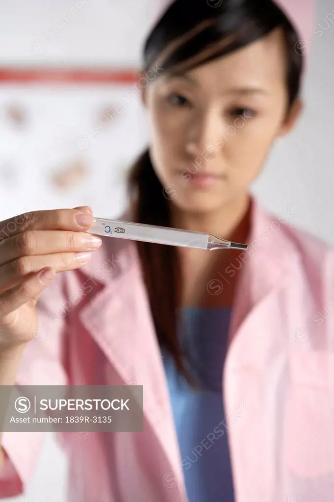 Nurse Holding A Thermometer