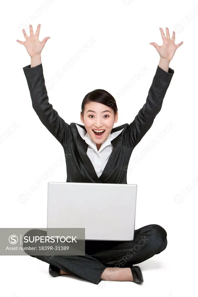 A businesswoman holding a laptop computer