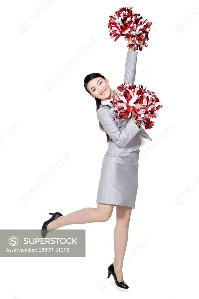 A businesswoman cheering with pompoms