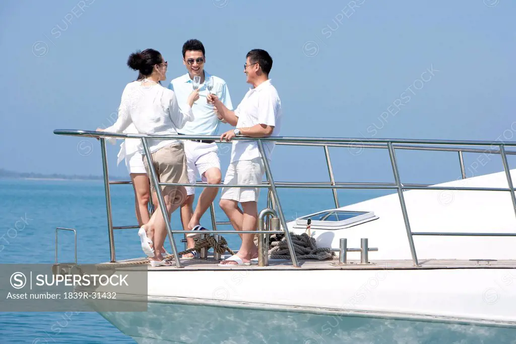 Friends Celebrating with Champagne on a Yacht