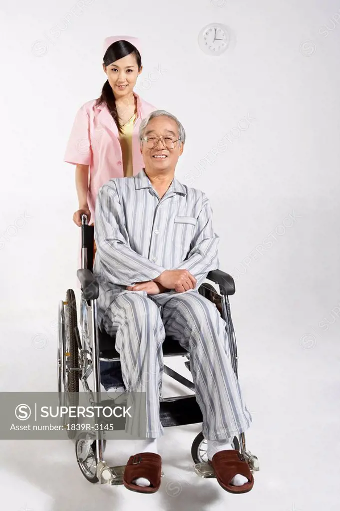 Nurse Pushing Patient In Wheelchair