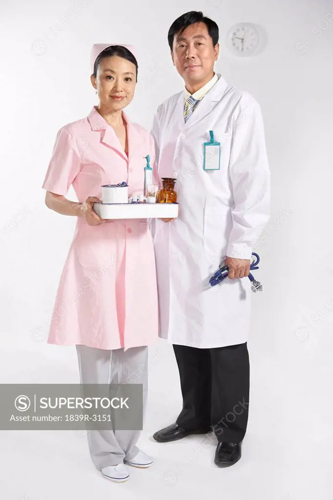 Doctor And Nurse With Medicine Tray