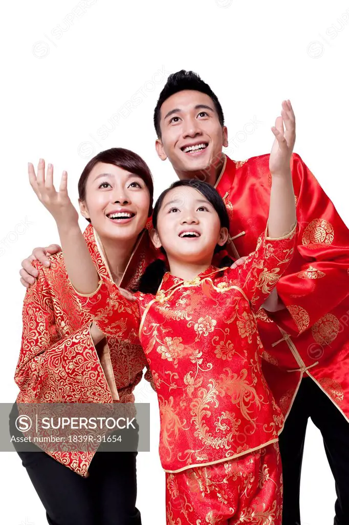 Family Dressed in Traditional Clothing Celebrating Chinese New Year