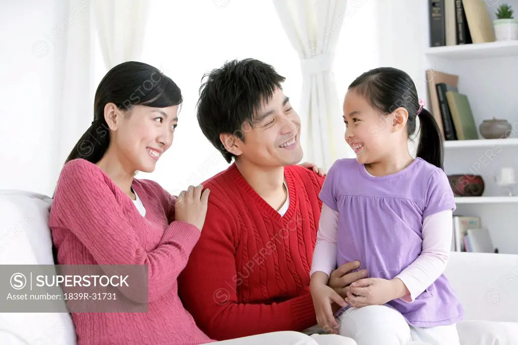Young Chinese family in living room