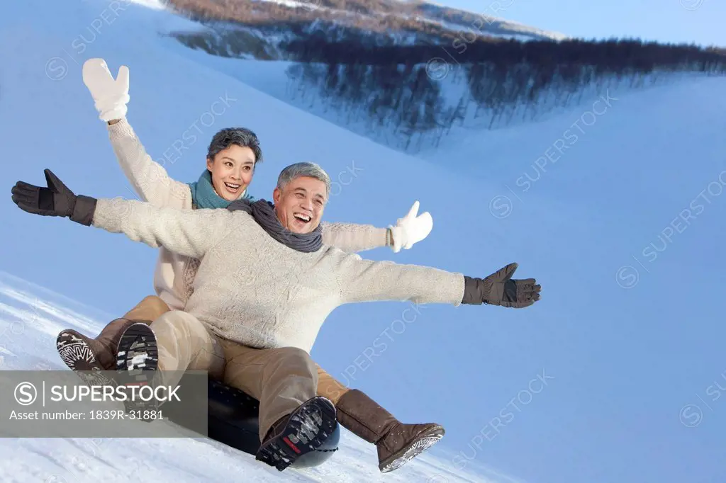 Senior couple having fun in snow