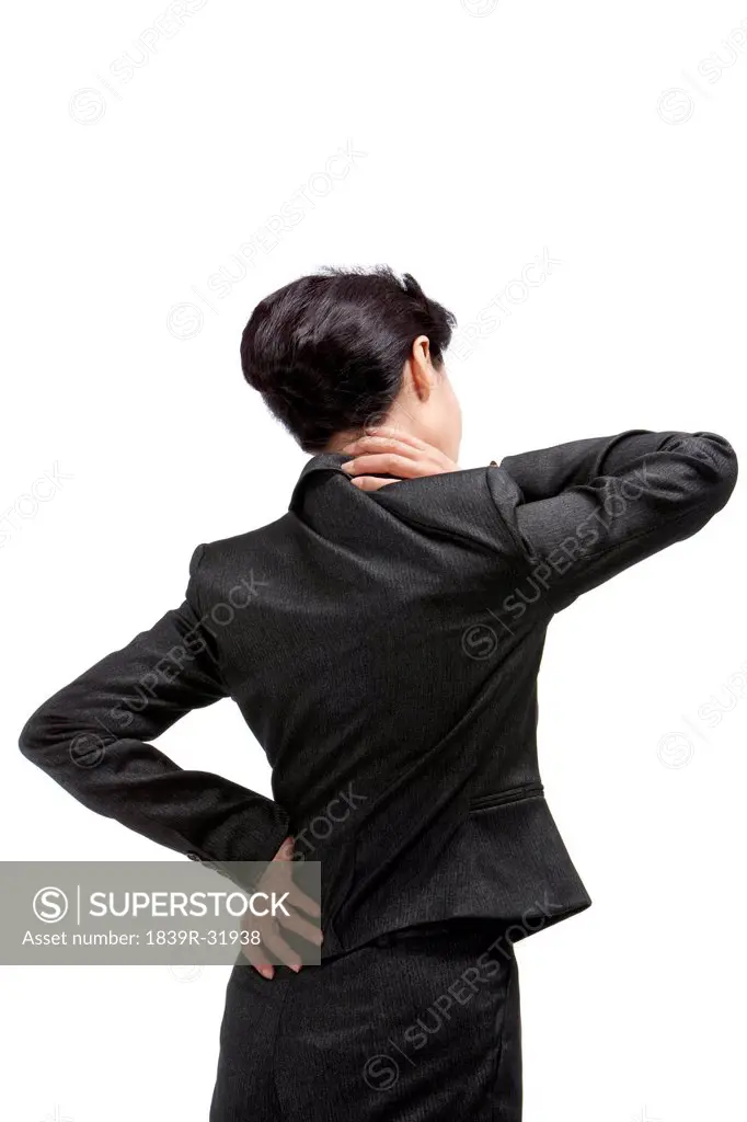 Middle_aged businesswoman suffering from backache and neck ache