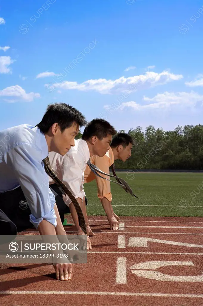 Businessmen Lined Up On A Race Track