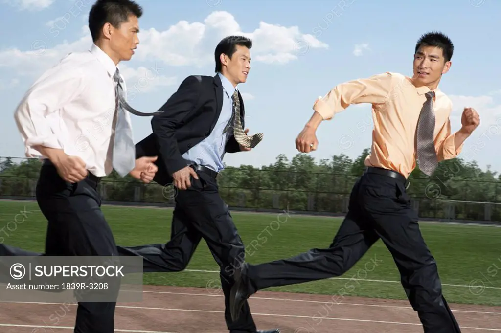 Businessmen Running Track In Their Suits