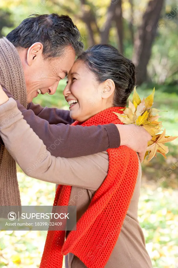 Senior couple smiling face to face in Autumn