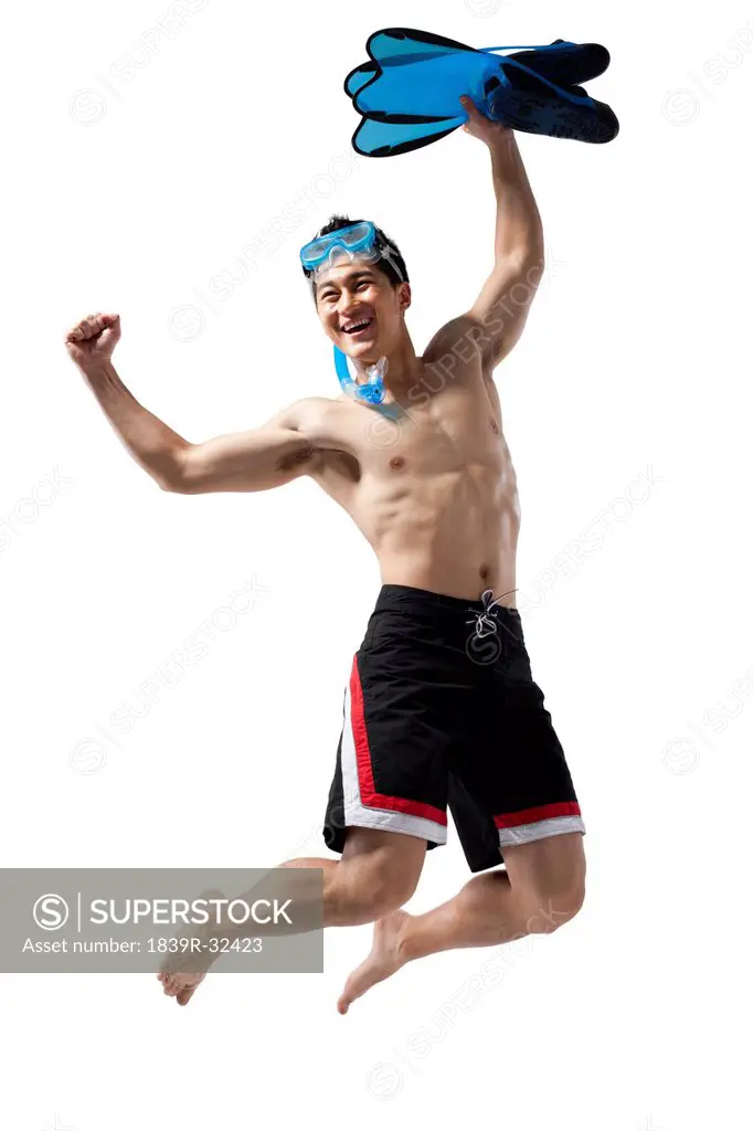 Man with swimming gear jumping in happiness