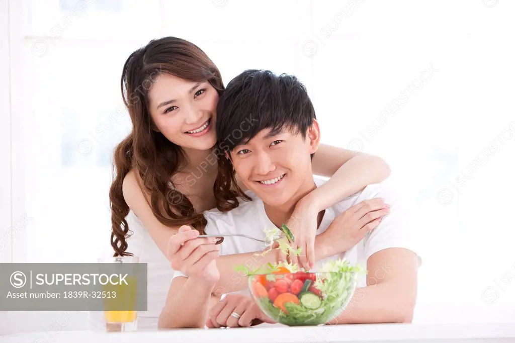 Young couple eating salad