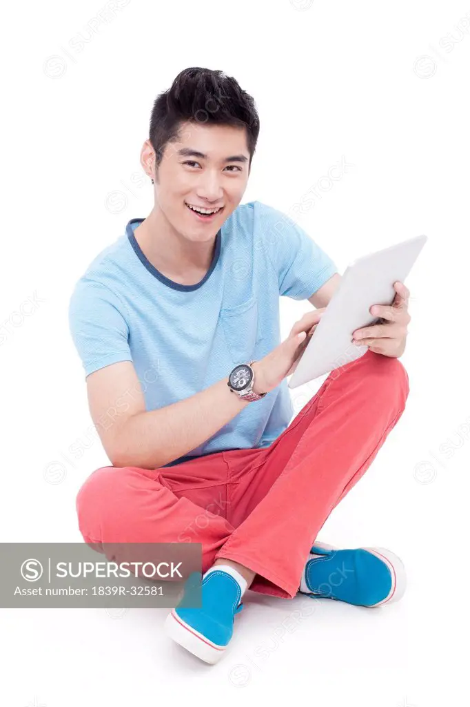 Happy young man and a digital tablet