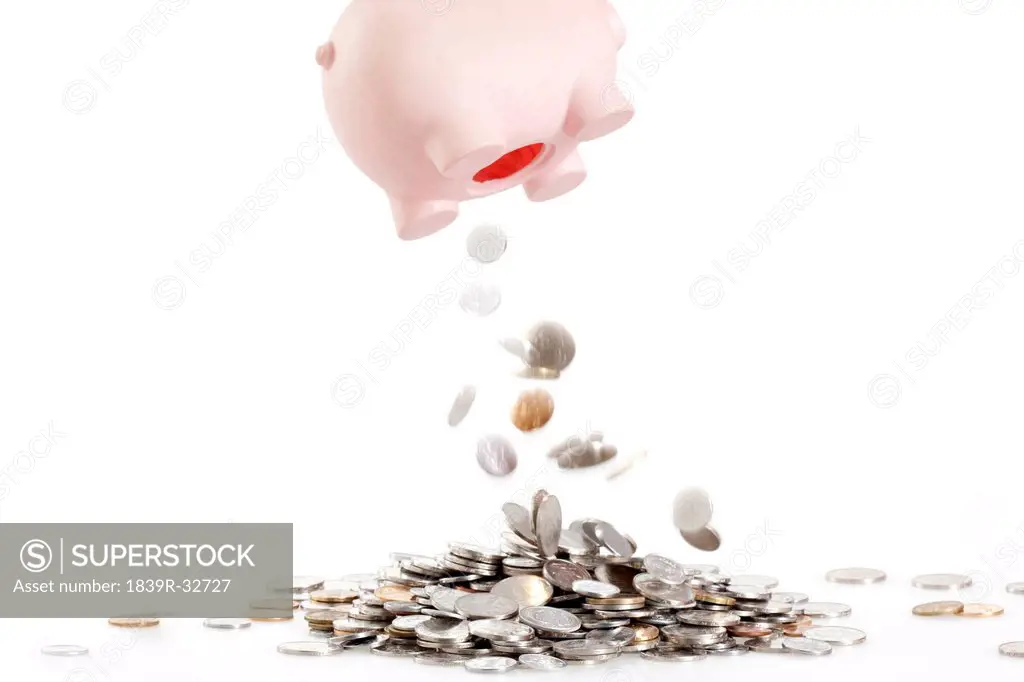 Coins dropping off from piggy bank