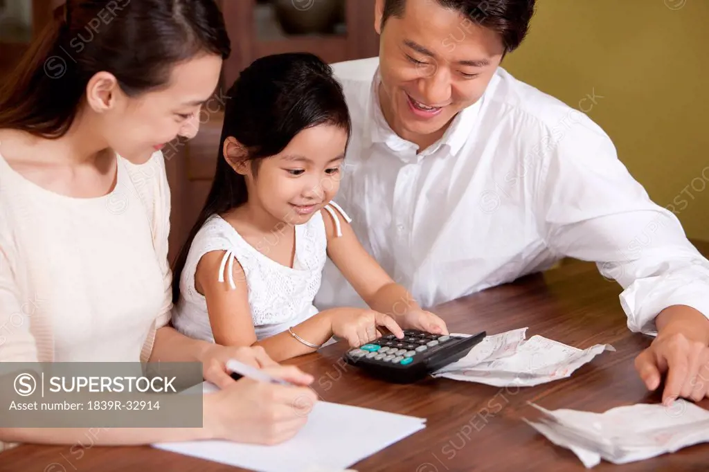 Family calculating bills together