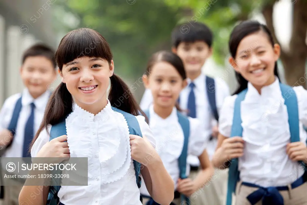 Lovely schoolchildren in uniform on the way to school