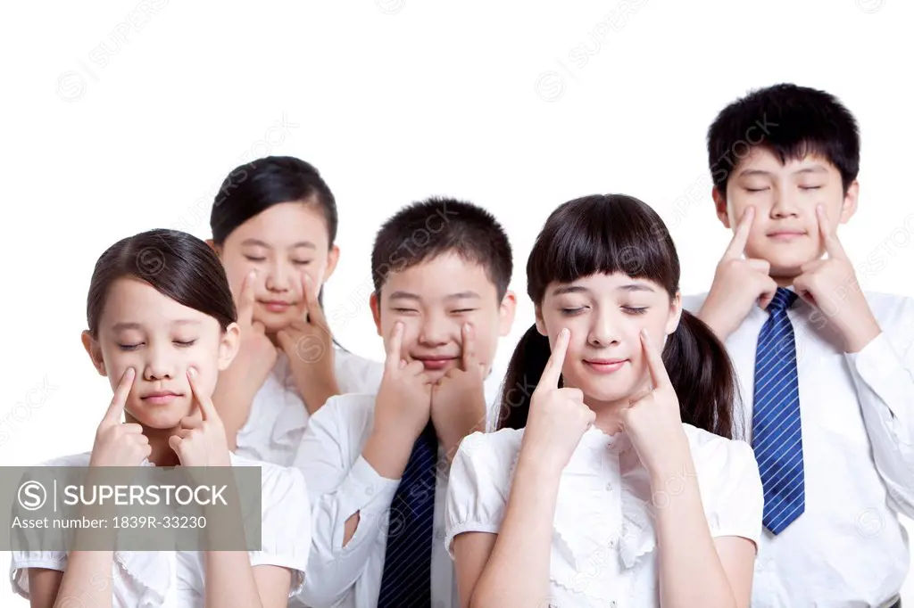 Portrait of schoolchildren doing eye exercises