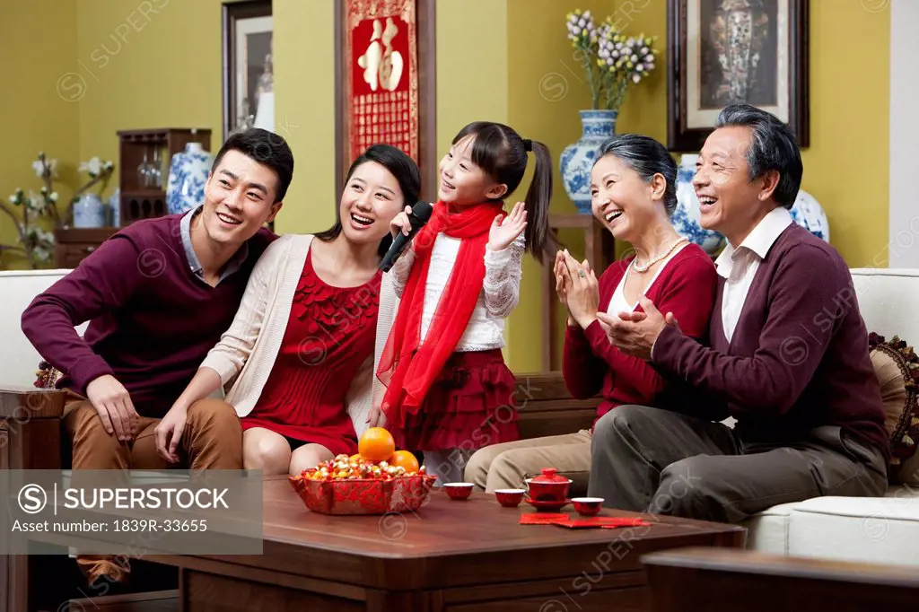 Happy family singing karaoke during Chinese New Year