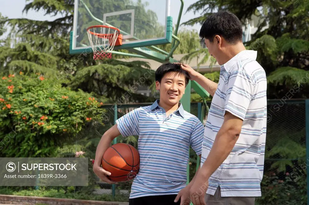 Father And Son On Basketball Court