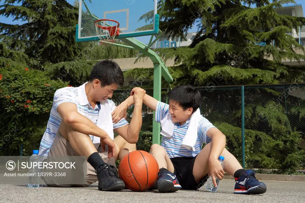 Father And Son Bonding On Basketball Court