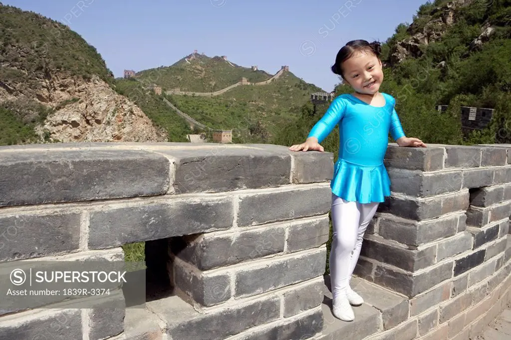 Portrait Of Young Girl In A Gymnastic Suit On The Great Wall Of China