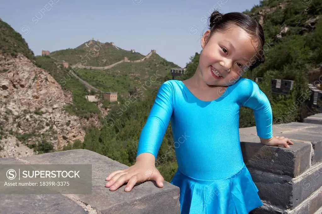 Portrait Of Young Girl In A Gymnastic Suit On The Great Wall Of China