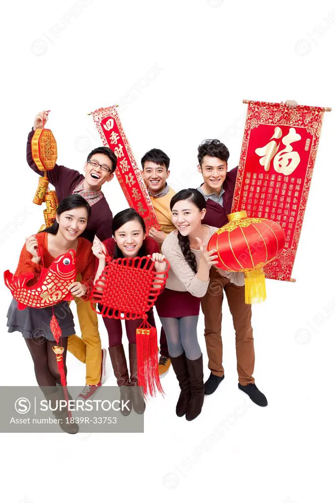 Cheerful young friends with decorations in Chinese New Year