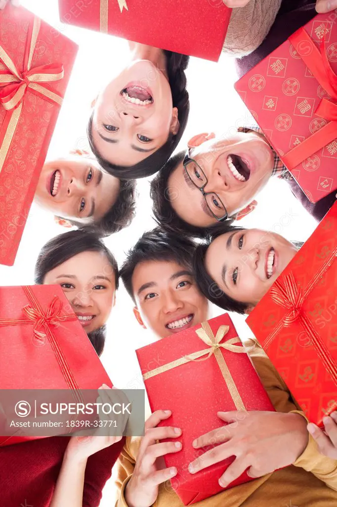 Happy young people with gifts in Chinese New Year
