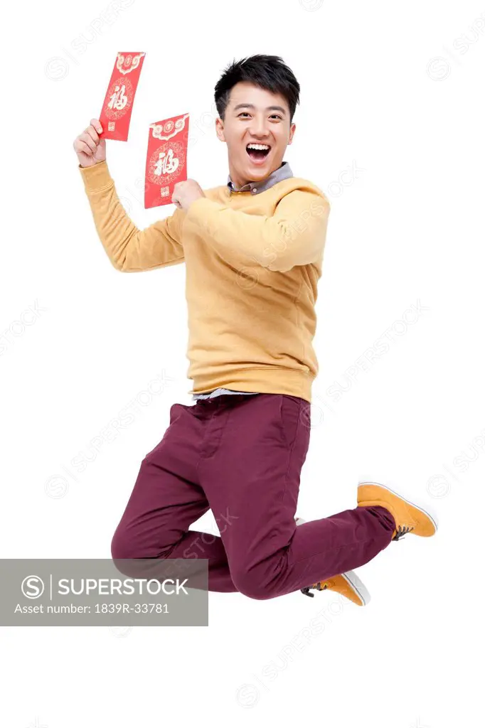 Excited young man with red pockets in Chinese New Year