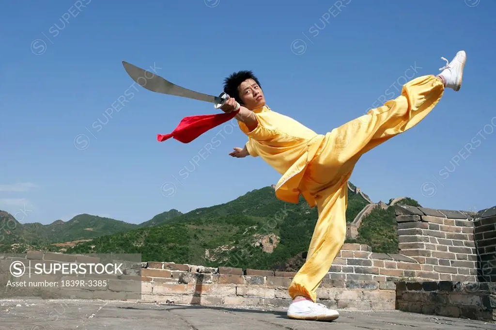 Portrait Of Young Man Practicing Martial Arts On The Great Wall Of China