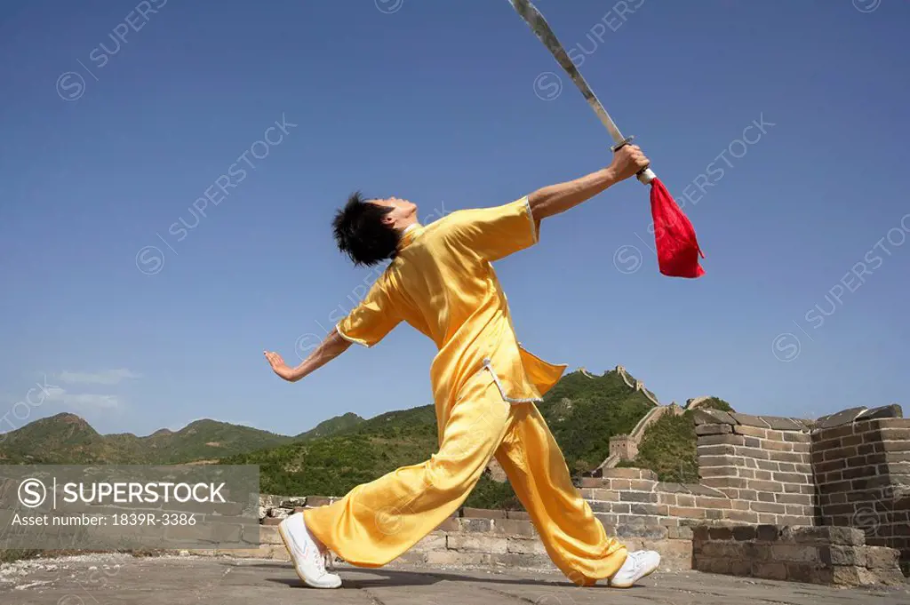 Portrait Of Young Man Practicing Martial Arts On The Great Wall Of China