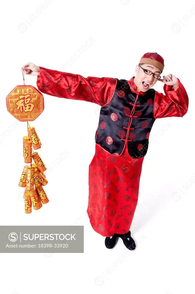 Excited young man in Tang suit and fireworks