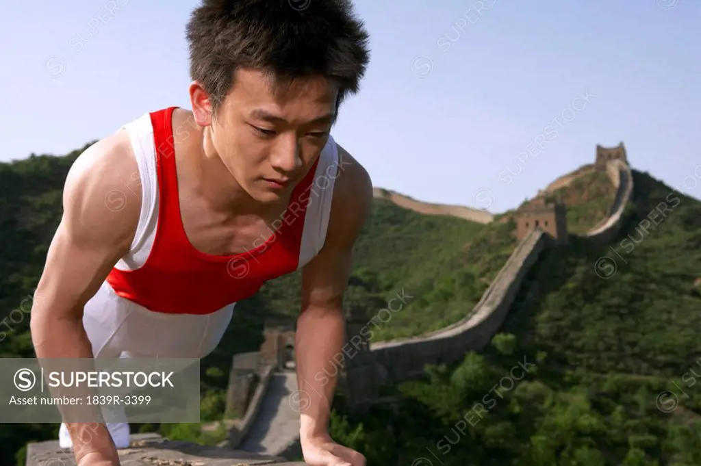 Gymnast Doing Push Up On The Great Wall Of China
