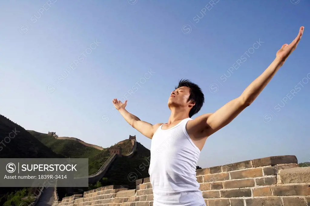 Man Doing Yoga On The Great Wall Of China