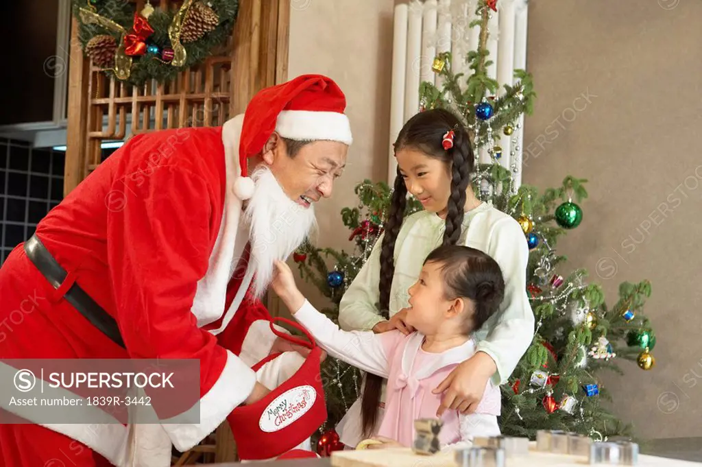 Santa Claus Giving Presents To Children