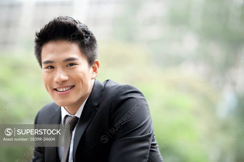 Portrait of cheerful young businessman outdoors, Hong Kong