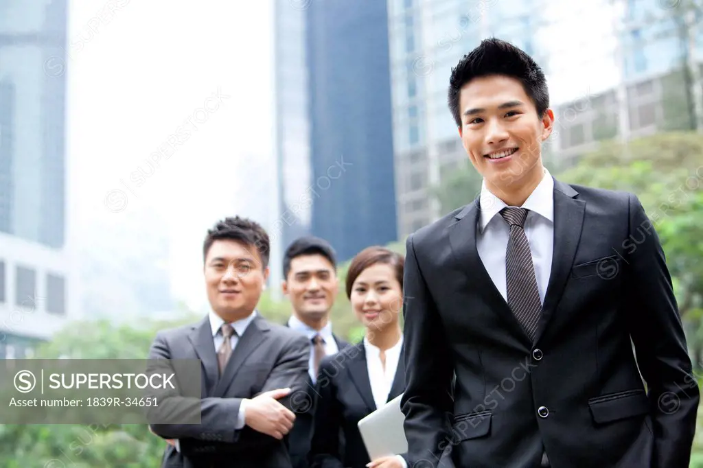 Cheerful businessman with his team in Hong Kong