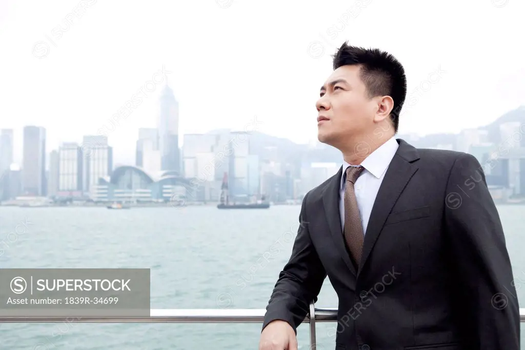 Adroit businessman looking at view, Hong Kong
