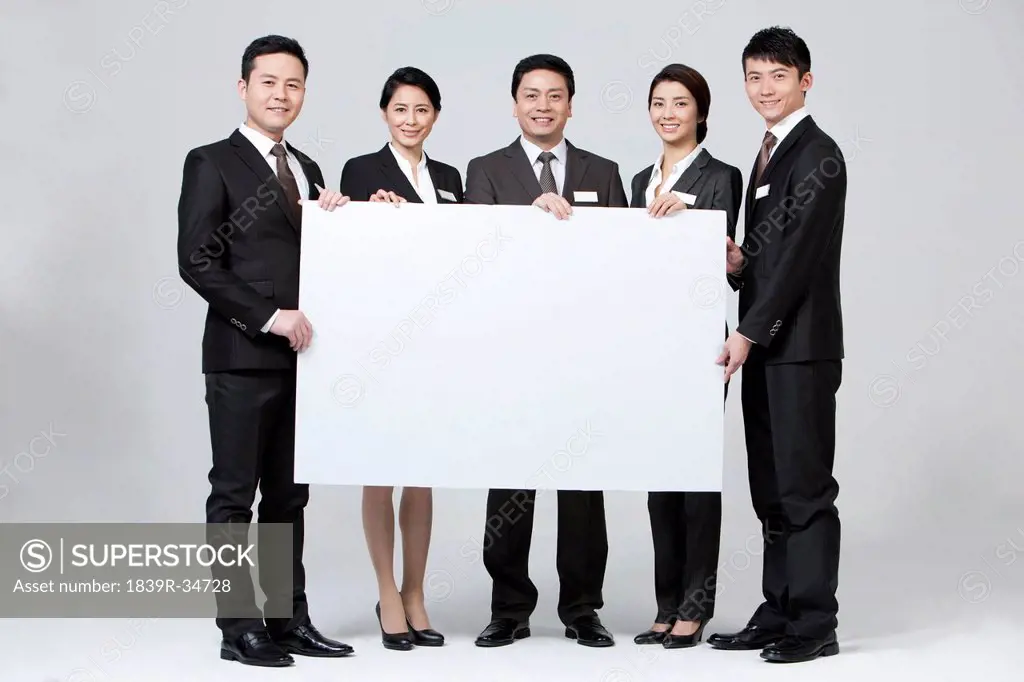 Happy business coworkers with a blank whiteboard