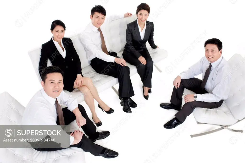 Professional business persons sitting in sofa