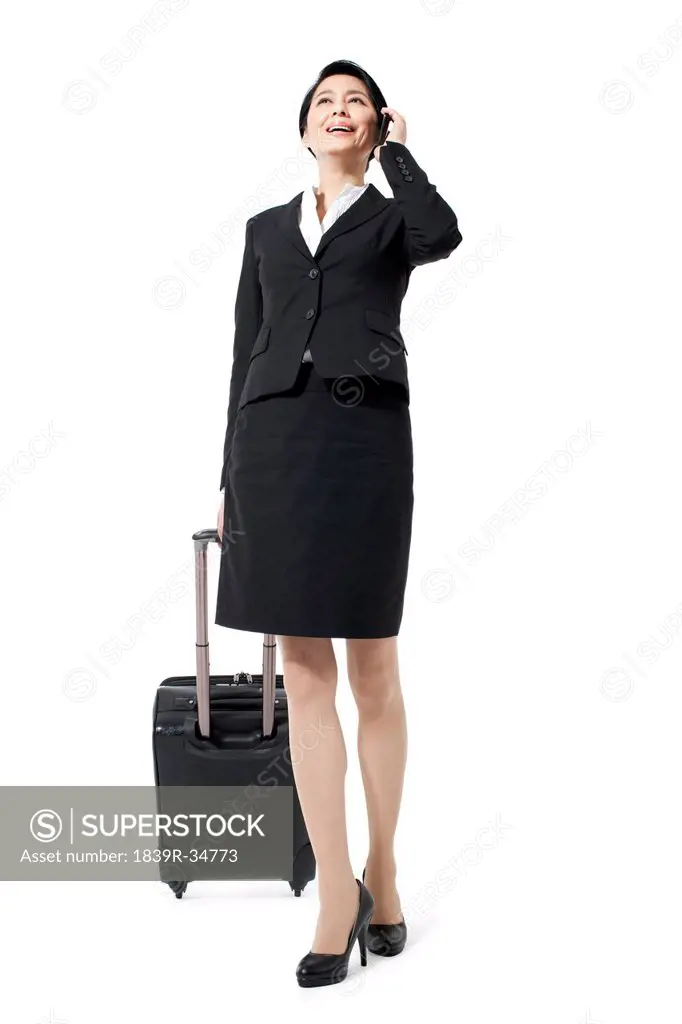 Cheerful businesswoman on a trip making a phone call