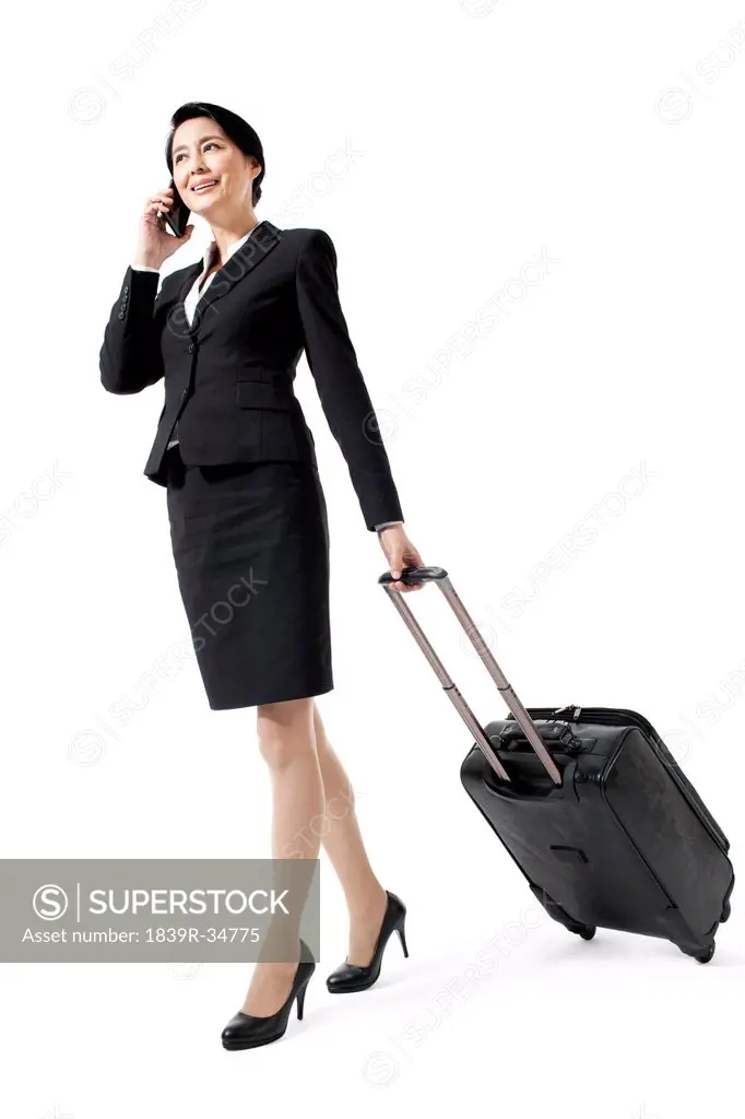 Cheerful businesswoman on a trip making a phone call