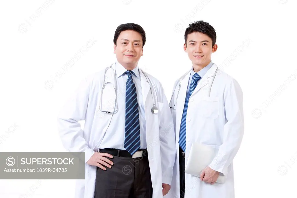 Portrait of two professional male doctors with digital tablet